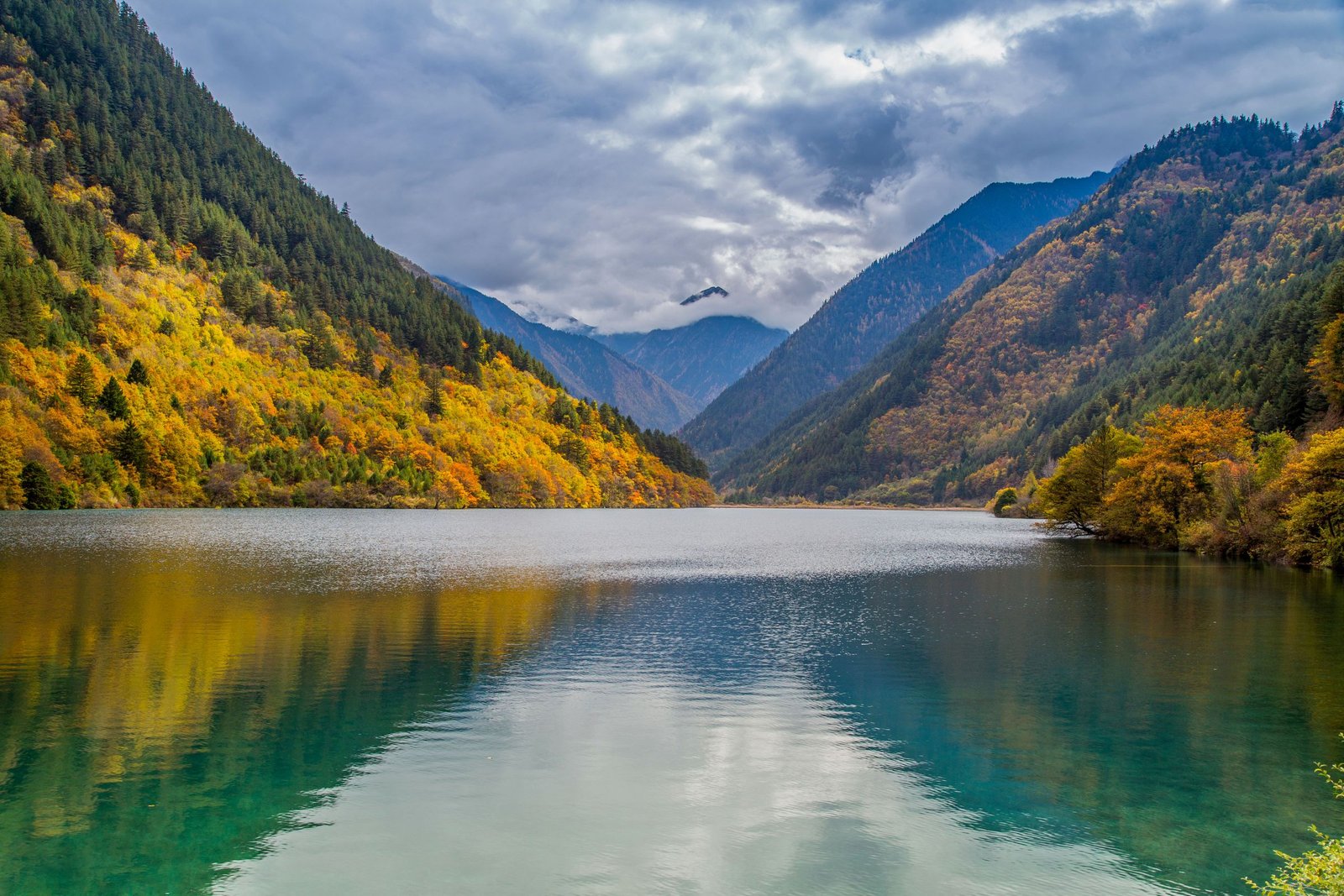 Wooded mountains and a lake in Jiuzhaigou.