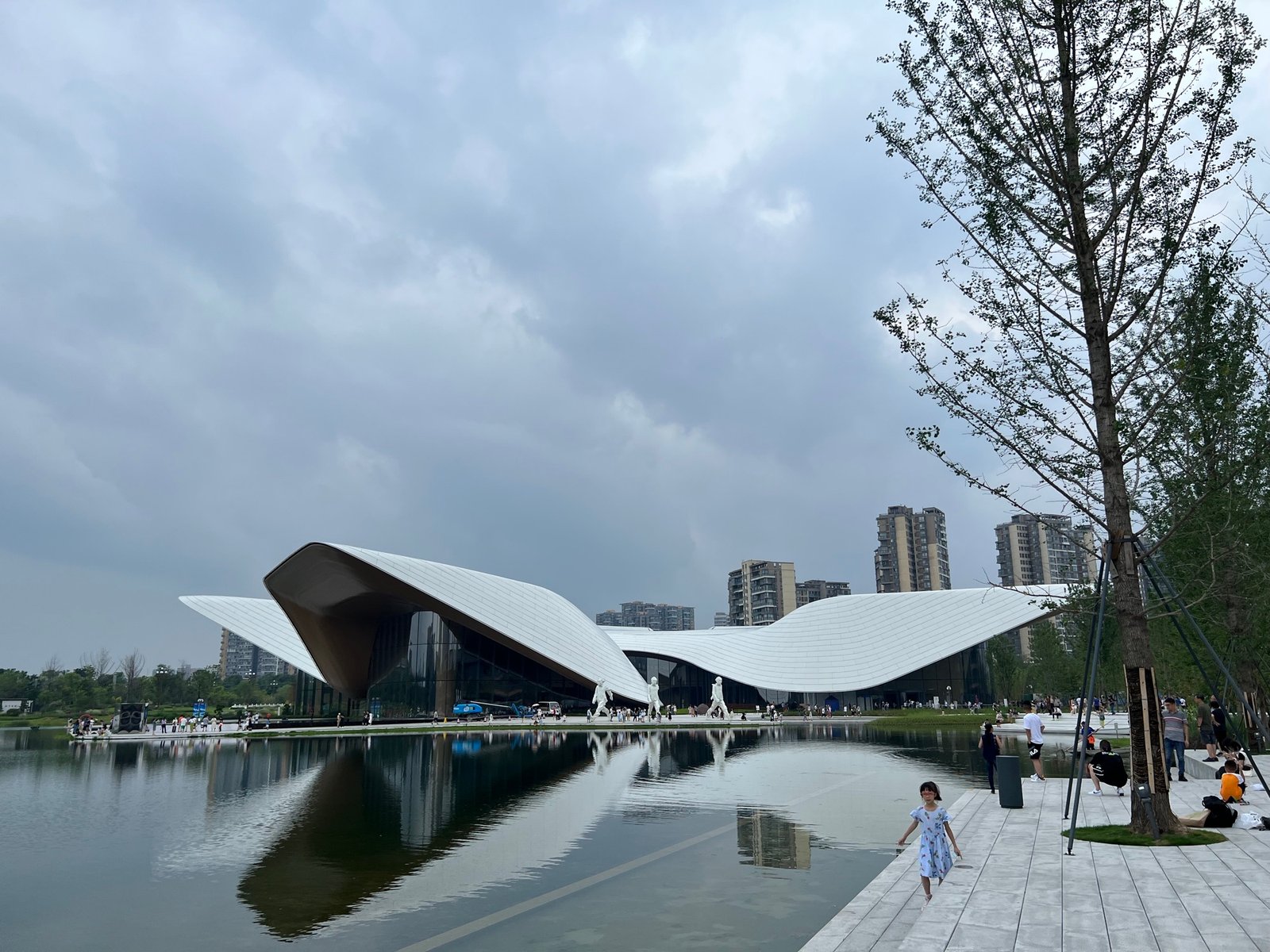 The sculptural museum building and reflecting pool at Tianfu Art Park in Chengdu.