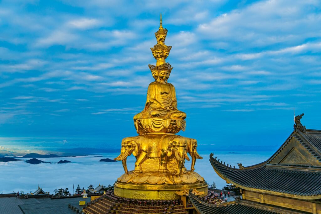 The complete golden Samantabhadra statue above clouds on Mount Emei.